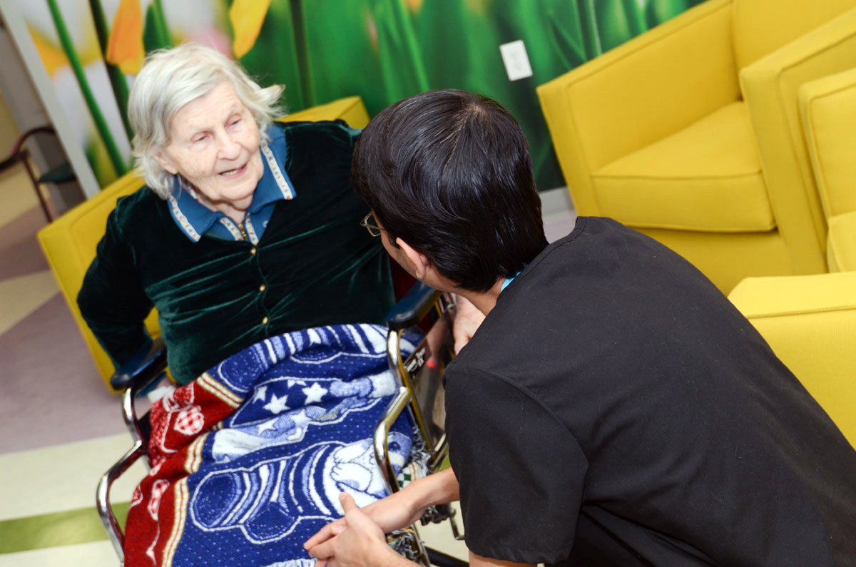 Woman talking to elderly patient