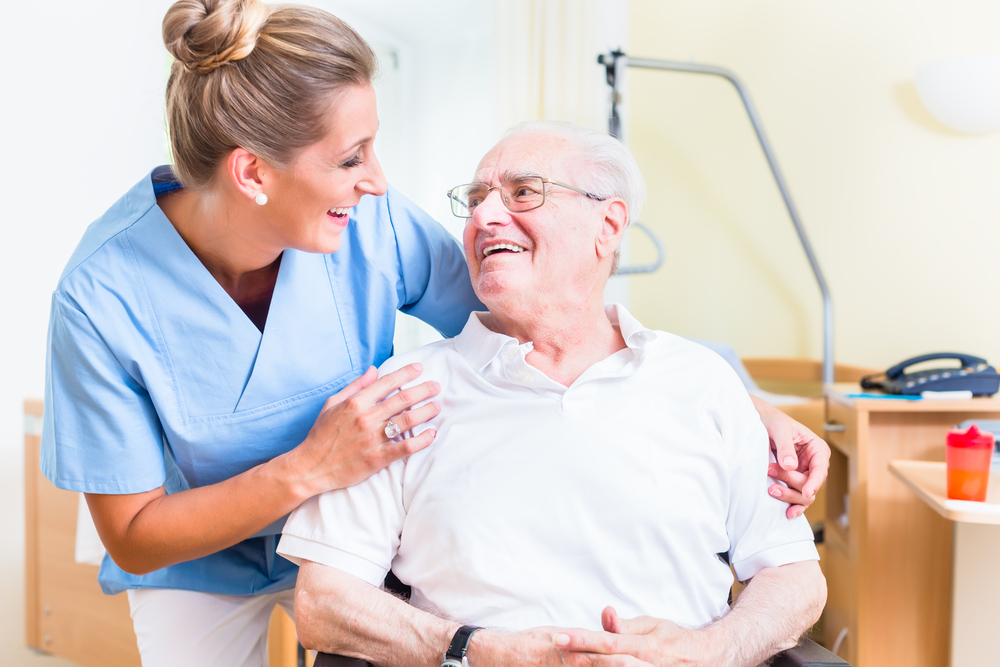 Senior man and old age nurse in nursing home.