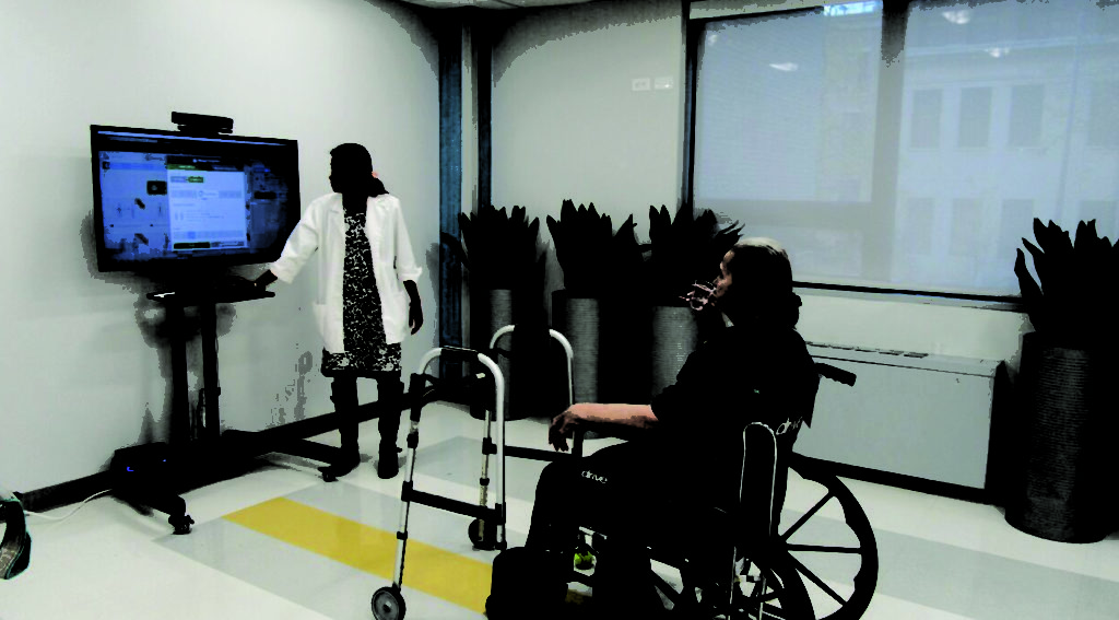Older patient using virtual reality glasses to see her spine while female doctor explains.